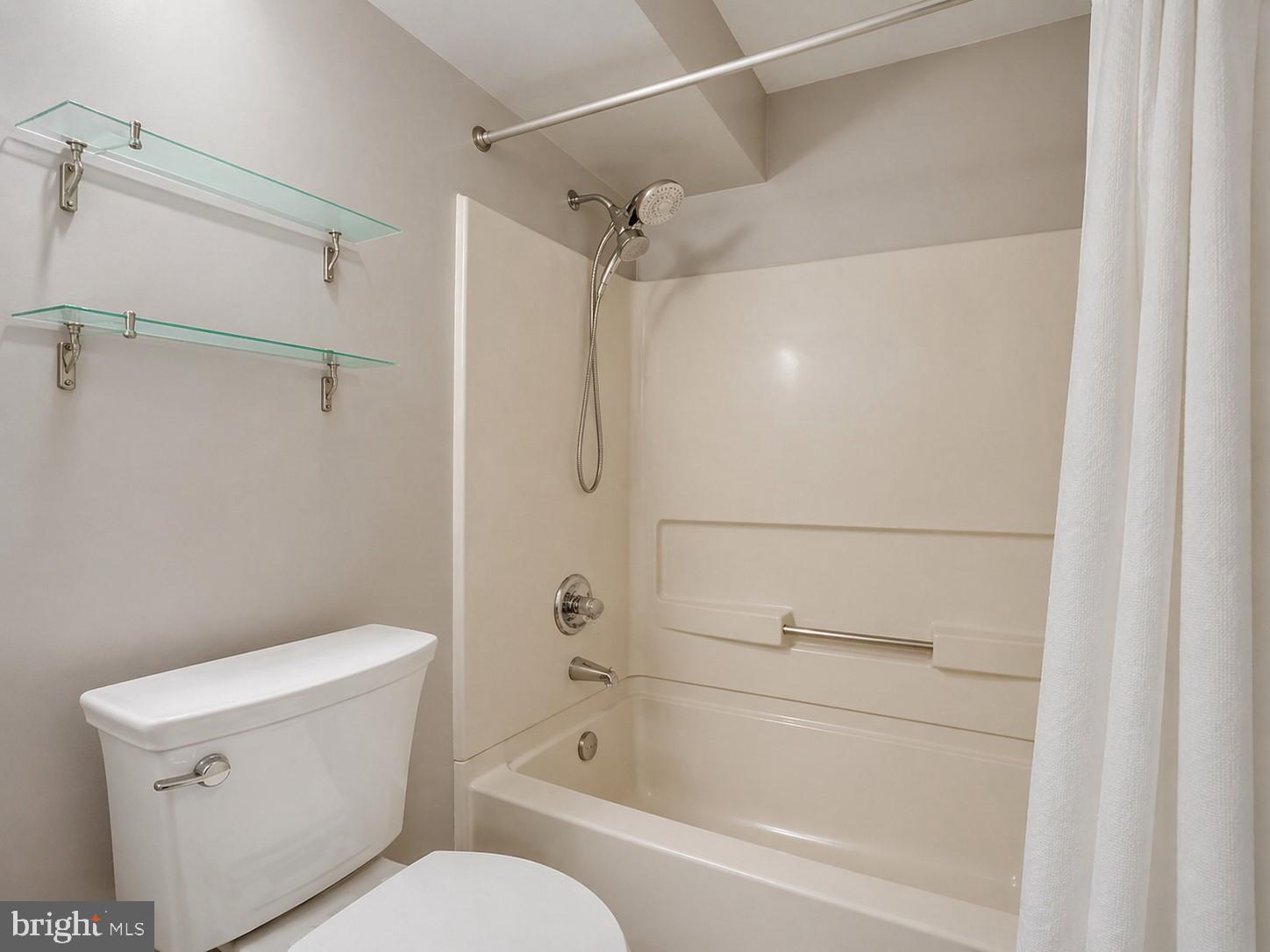 8353 Montgomery Run Road, Unit F Ellicott City, MD 21043 - Photo 16 of 25 a bathroom with a shower and a toilet