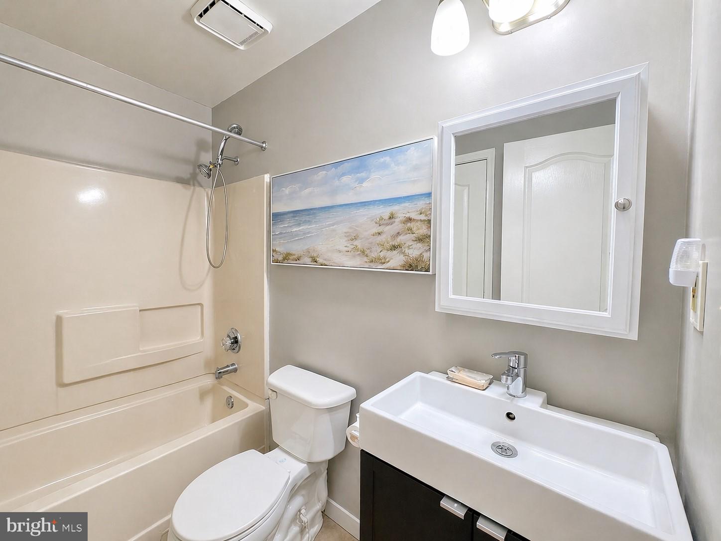 8353 Montgomery Run Road, Unit F Ellicott City, MD 21043 - Photo 19 of 25 a bathroom with a sink toilet and shower