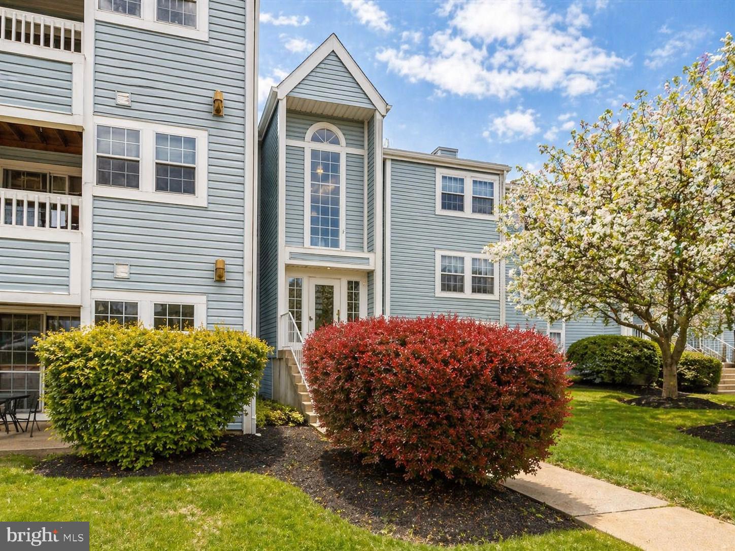8353 Montgomery Run Road, Unit F Ellicott City, MD 21043 - Photo 2 of 25 a front view of a house with garden