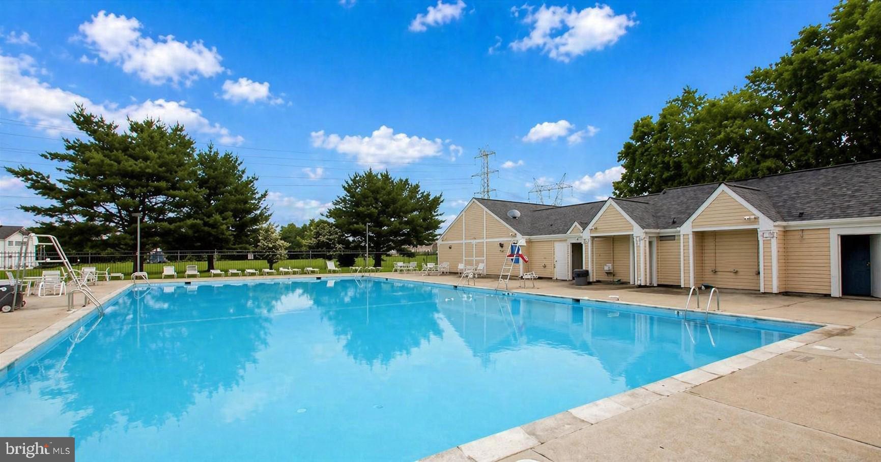 8353 Montgomery Run Road, Unit F Ellicott City, MD 21043 - Photo 23 of 25 a view of a house with swimming pool and a yard