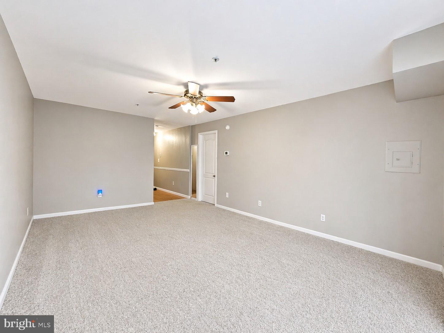 8353 Montgomery Run Road, Unit F Ellicott City, MD 21043 - Photo 6 of 25 a view of an empty room with a chandelier fan
