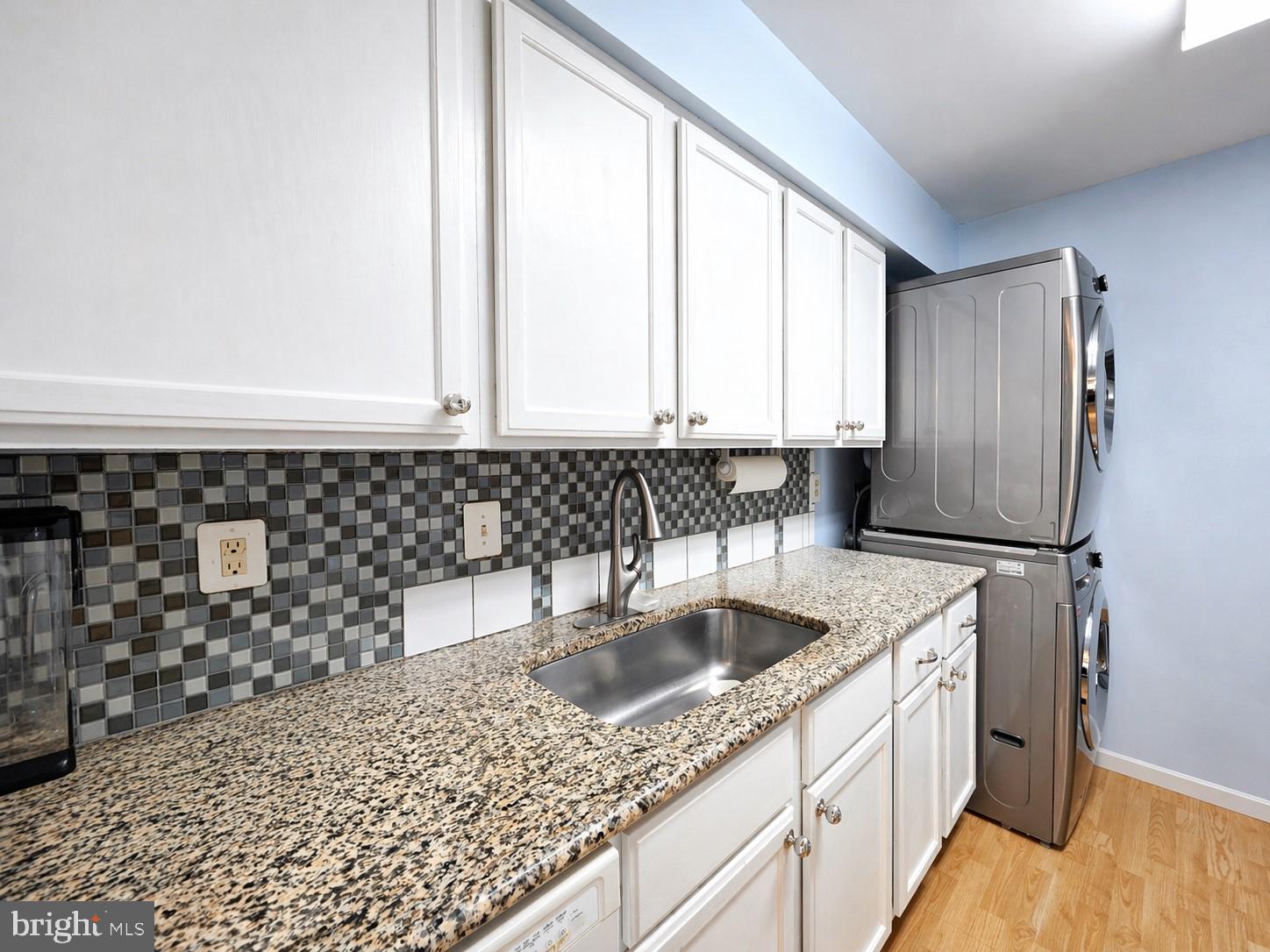 8353 Montgomery Run Road, Unit F Ellicott City, MD 21043 - Photo 9 of 25 a kitchen with stainless steel appliances granite countertop a sink and a granite counter tops