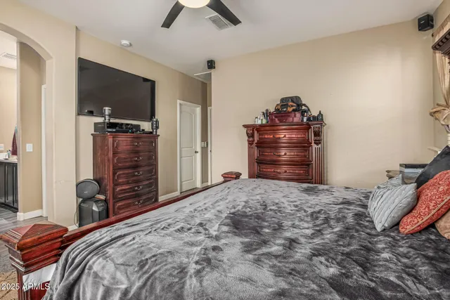 a bedroom with a bed and a television