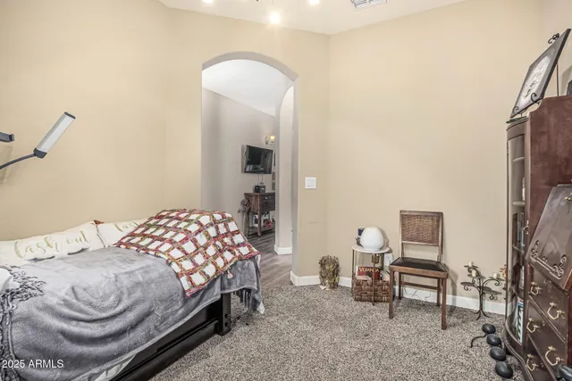 a bedroom with a bed and a chair