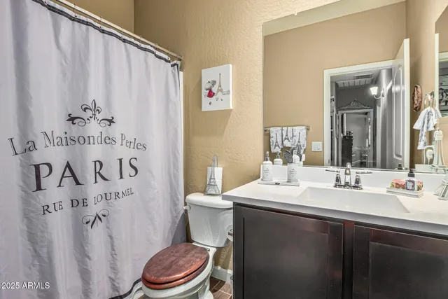 a bathroom with a sink a toilet and a mirror