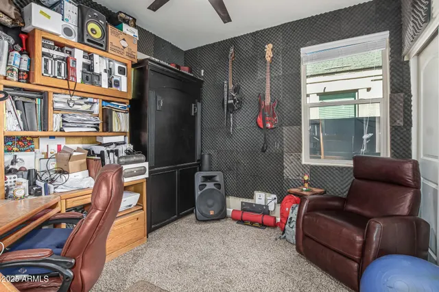 a living room with furniture cabinets and a window