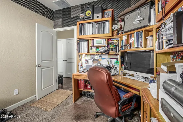 a view of a livingroom with furniture and a workspace