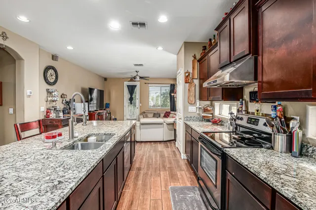 a kitchen with stainless steel appliances granite countertop a lot of counter space
