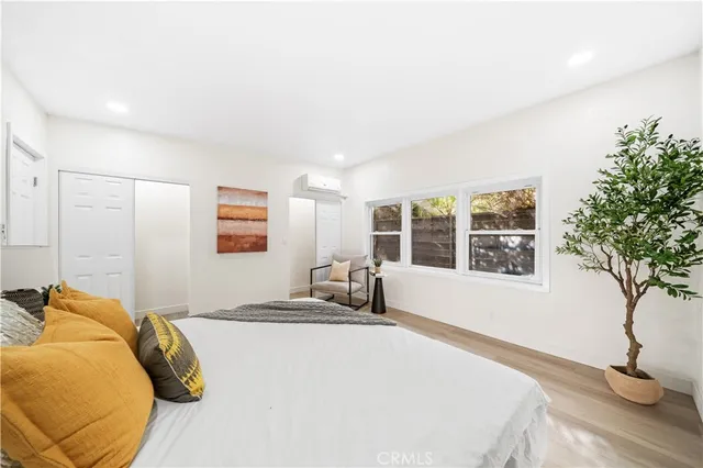 a bedroom with a bed and a potted plant