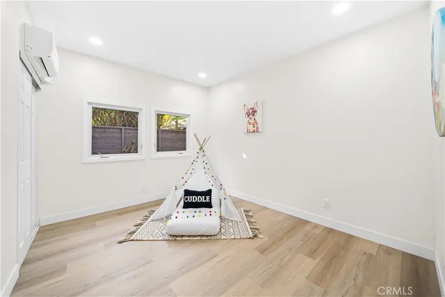 a view of wooden floor and entryway in a room