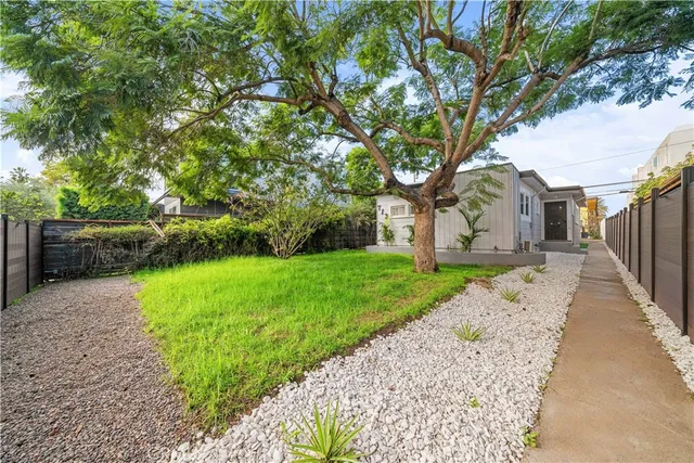 a view of a house with a tree in the background