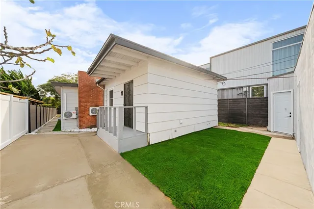 a view of a backyard with plants and a garage