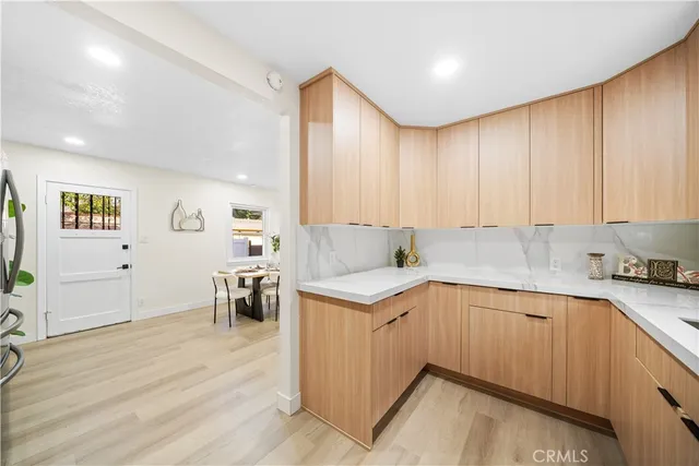 a kitchen with a sink cabinets and wooden floor