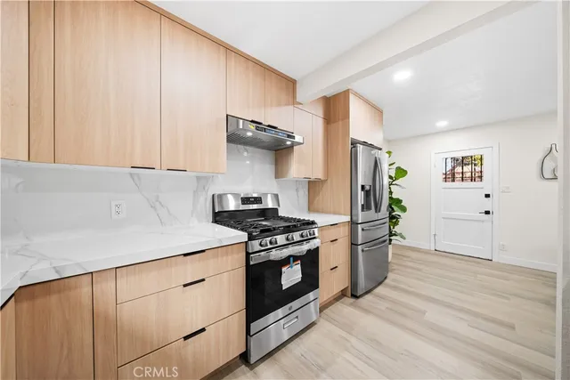 a kitchen with a stove and a refrigerator