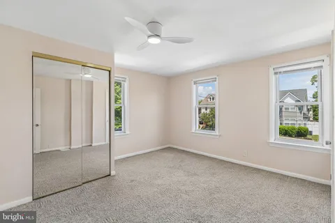 an empty room with windows and closet