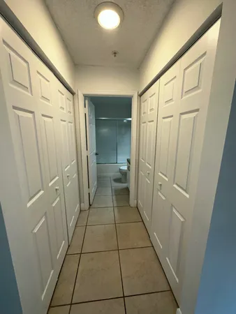 a bathroom with a granite countertop shower and a mirror