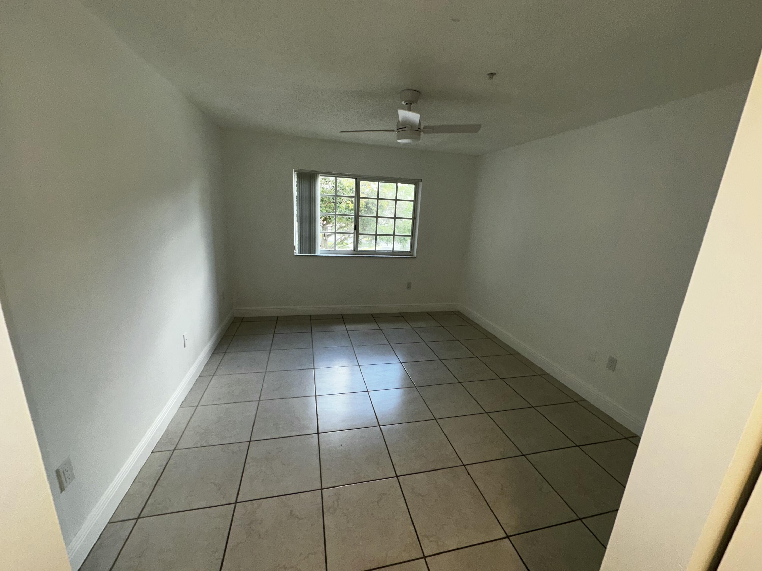 2103 Renaissance Boulevard, Unit 306 Miramar, FL 33025 - Photo 14 of 44 a view of an empty room and a window