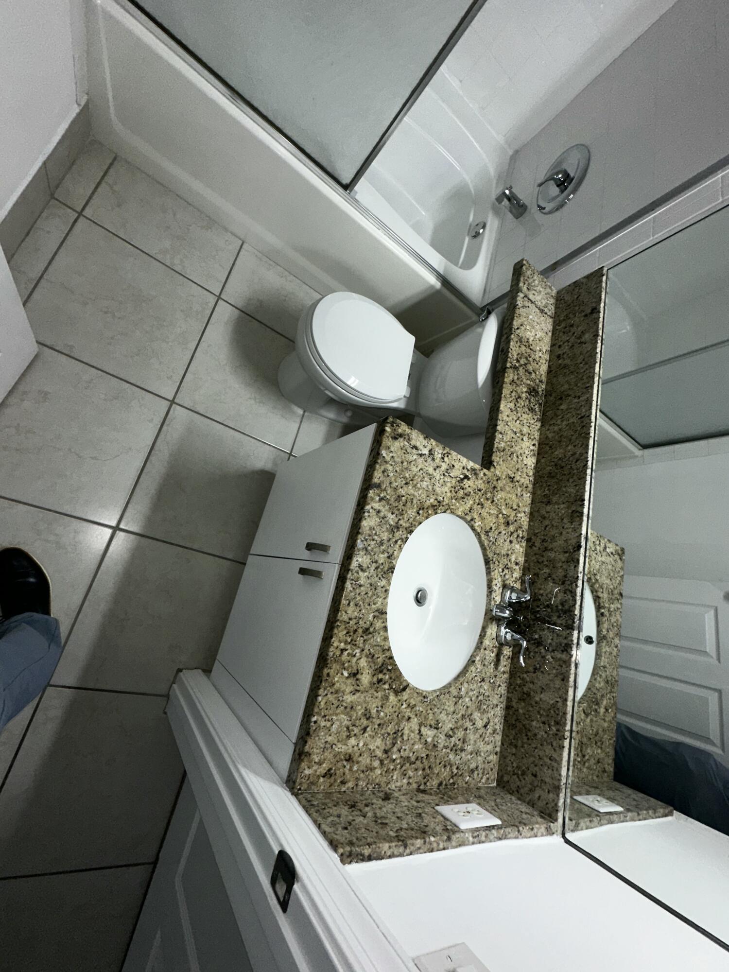 2103 Renaissance Boulevard, Unit 306 Miramar, FL 33025 - Photo 15 of 44 a bathroom with a toilet and a mirror