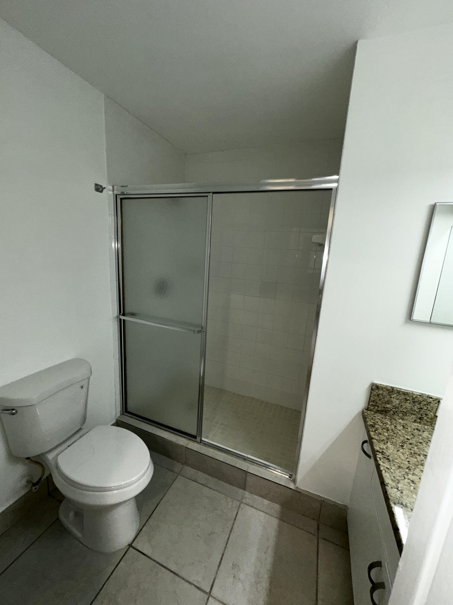 2103 Renaissance Boulevard, Unit 306 Miramar, FL 33025 - Photo 20 of 44 a bathroom with a toilet and a shower