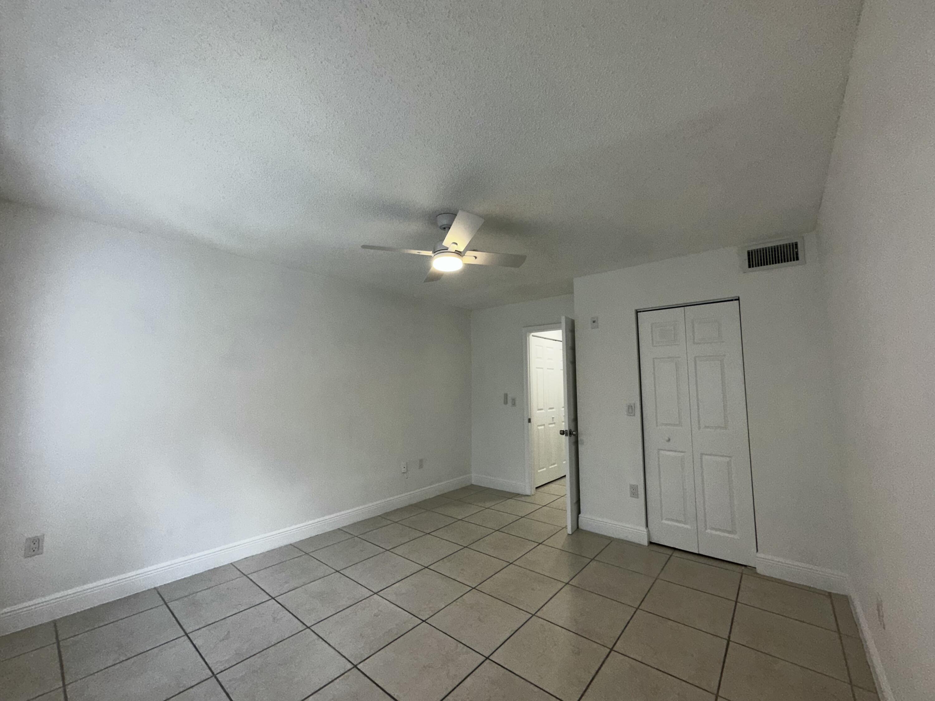 2103 Renaissance Boulevard, Unit 306 Miramar, FL 33025 - Photo 22 of 44 an empty room with chandelier fan