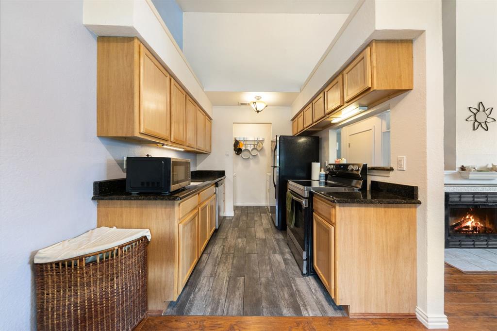 2240 Tarpley Road, Unit 411 Carrollton, TX 75006 - Photo 8 of 28 a kitchen with stainless steel appliances granite countertop a stove a sink and a refrigerator