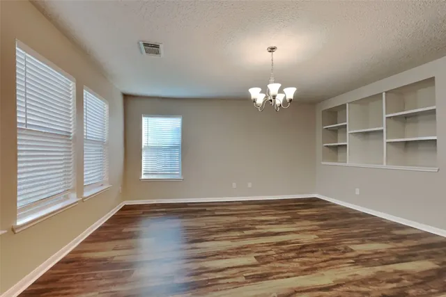 a view of a room with windows and chandelier