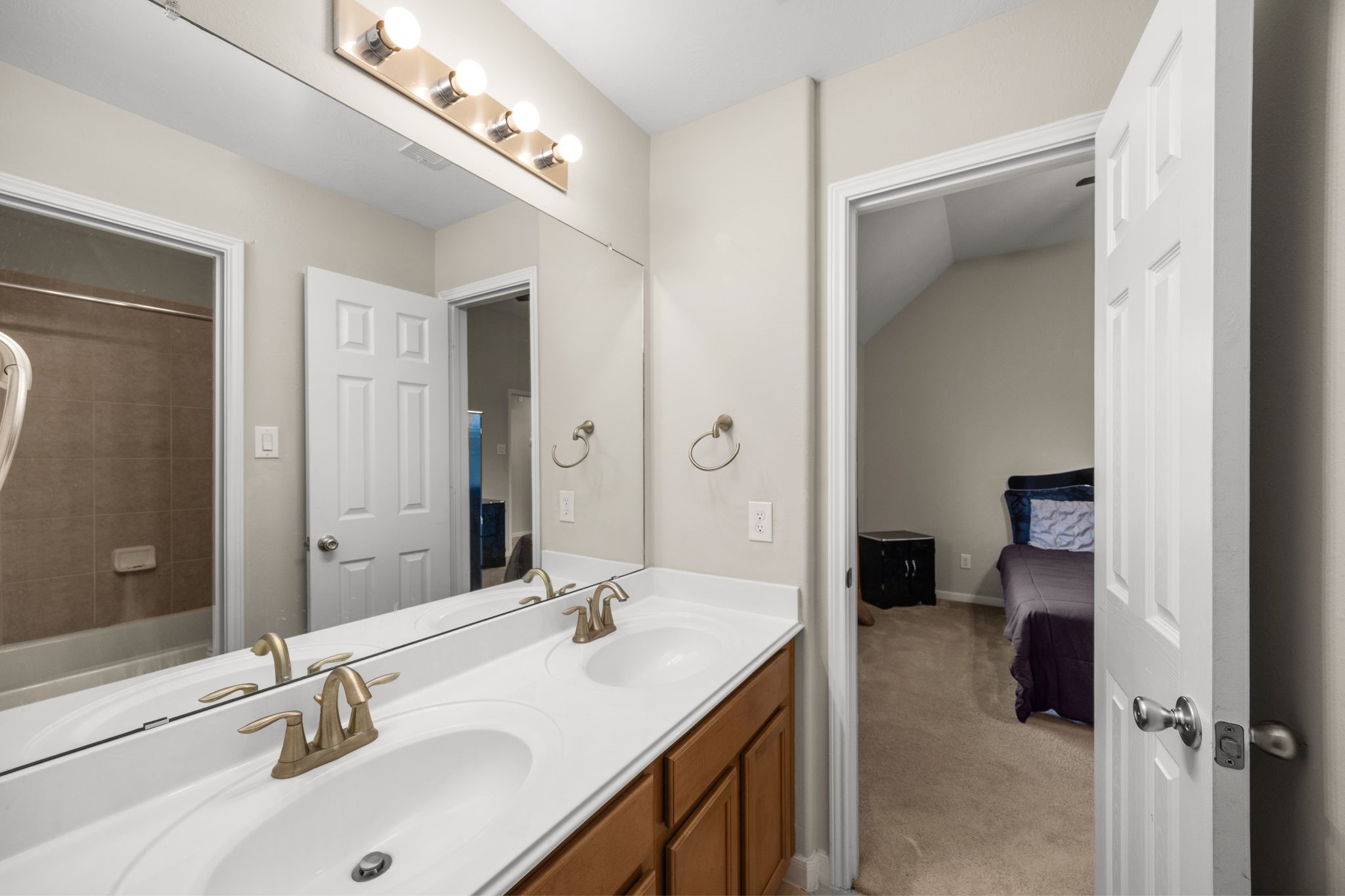 6719 Latchmore Lane Houston, TX 77049 - Photo 30 of 46 a en suite bathroom with a double vanity sink and a mirror