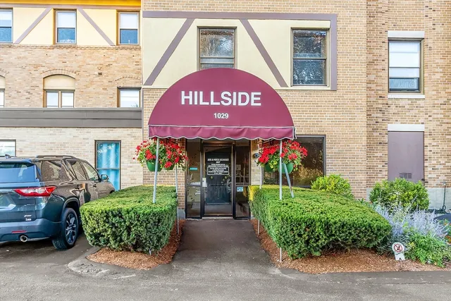 a front view of a building with garden