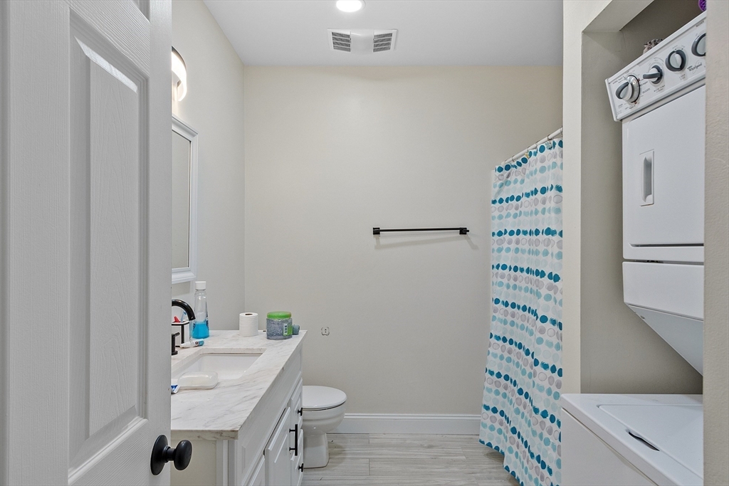 1029 Pleasant Street, Unit 19 Worcester, MA 01602 - Photo 16 of 23 a bathroom with a sink toilet and shower