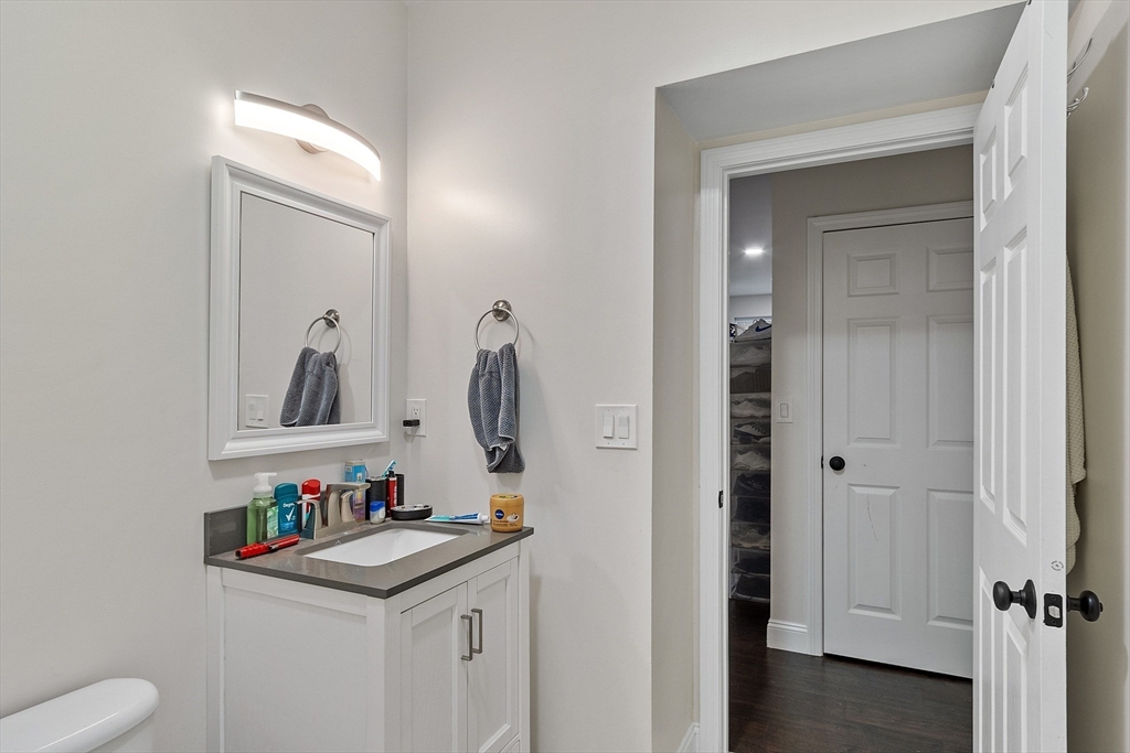 1029 Pleasant Street, Unit 19 Worcester, MA 01602 - Photo 19 of 23 a bathroom with a sink and a mirror