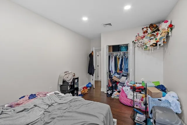 a bedroom with a bed and cabinets