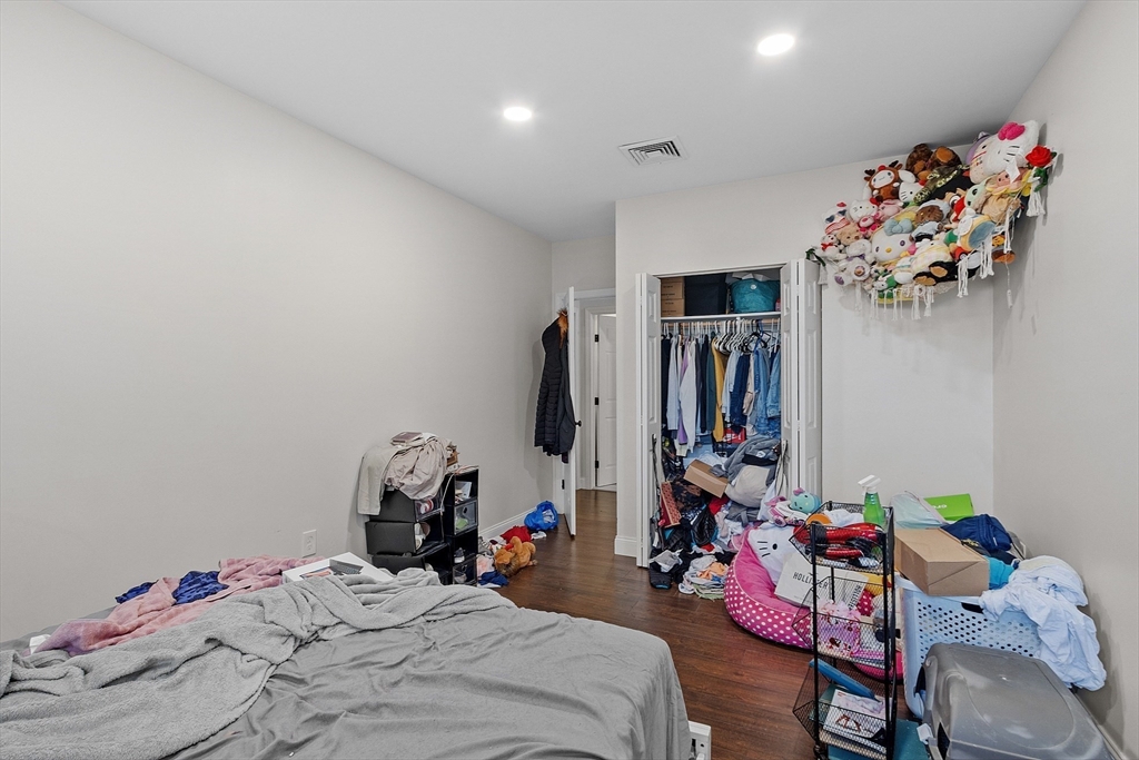 1029 Pleasant Street, Unit 19 Worcester, MA 01602 - Photo 22 of 23 a bedroom with a bed and cabinets