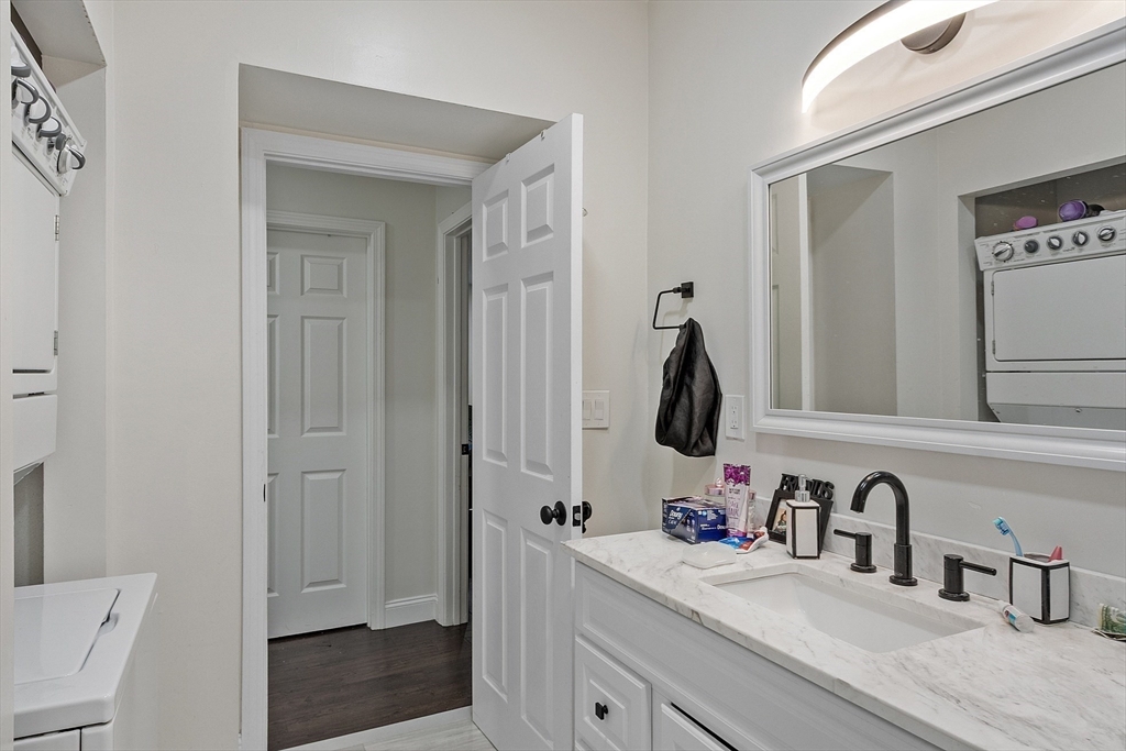 1029 Pleasant Street, Unit 19 Worcester, MA 01602 - Photo 23 of 23 a bathroom with a sink a toilet and mirror