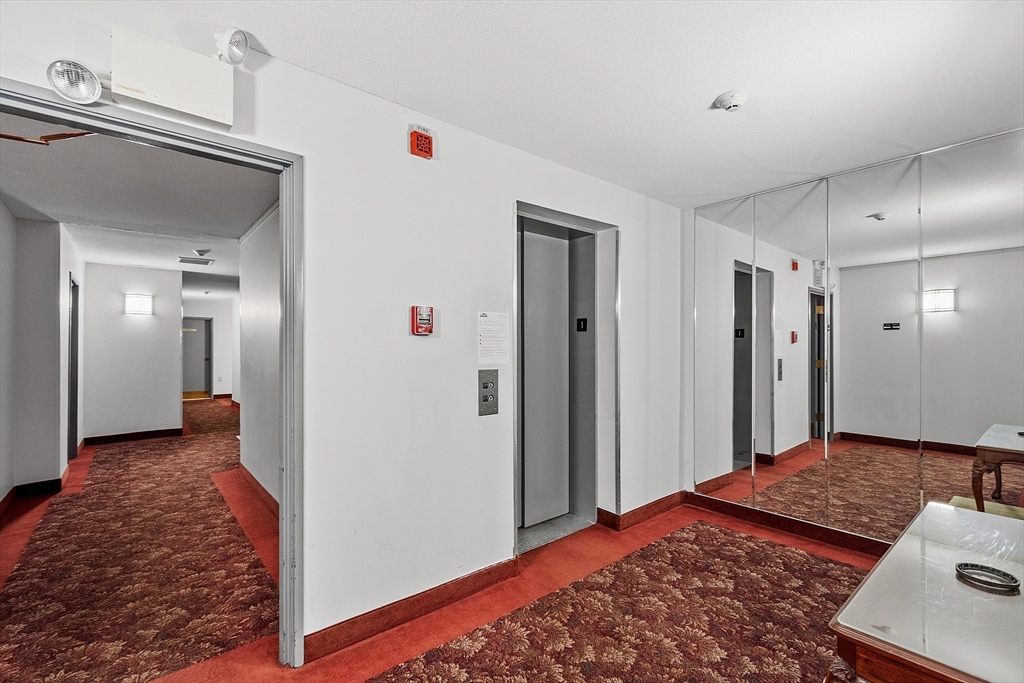 1029 Pleasant Street, Unit 19 Worcester, MA 01602 - Photo 4 of 23 a view of a bedroom with closet and wooden floor