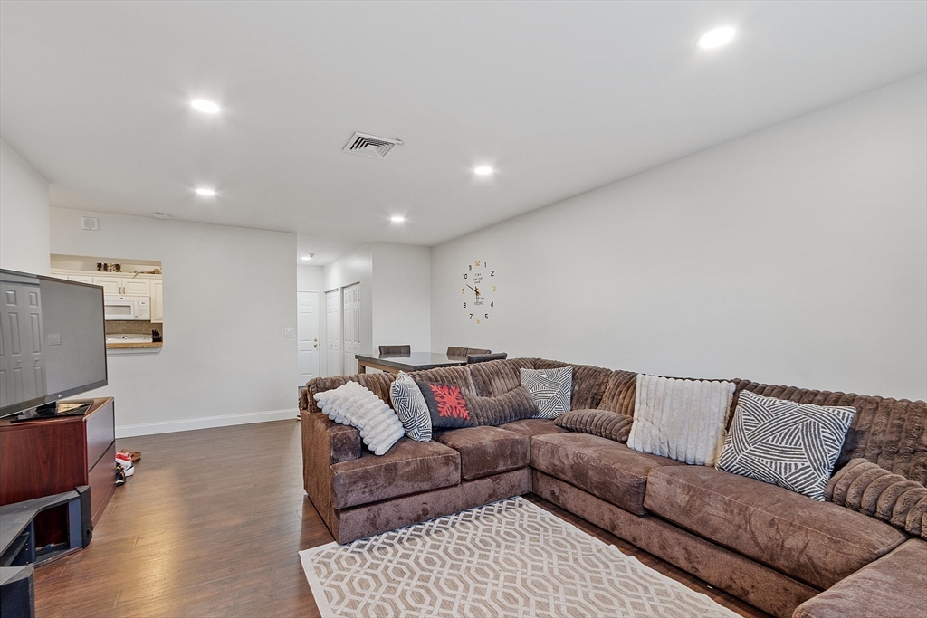1029 Pleasant Street, Unit 19 Worcester, MA 01602 - Photo 10 of 23 a living room with furniture and a flat screen tv