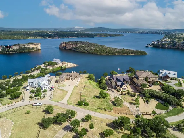 an aerial view of a houses with ocean view