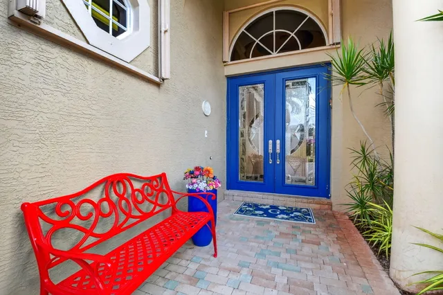 a living room with furniture dining table a flat screen tv and a large window