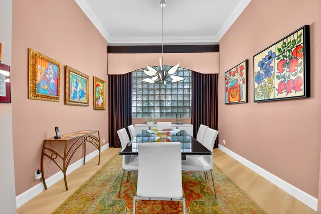 a kitchen with stainless steel appliances granite countertop a refrigerator a sink dishwasher a stove and a dining table with wooden floor