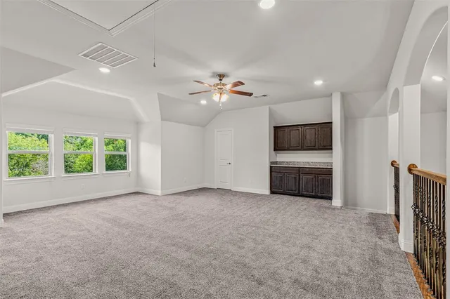 a view of a kitchen with a sink a kitchen area refrigerator and a dishwasher