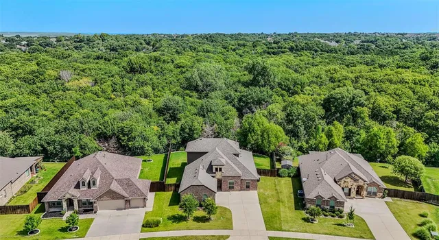 an aerial view of a house with garden space and street view