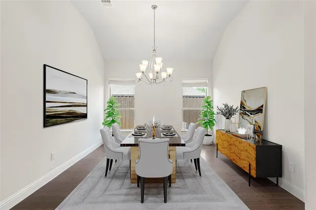 a view of a dining room with furniture a chandelier and wooden floor