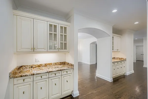 a kitchen with granite countertop a stove and a refrigerator