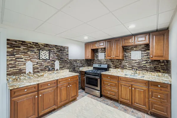 a bedroom with a bed and a black white checkered floor