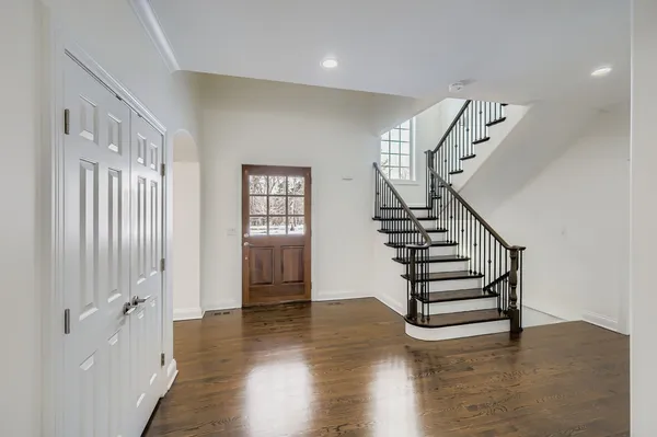 a view of entryway with wooden floor and stairs