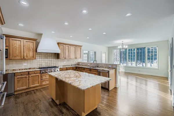 a kitchen with a stove sink and cabinets