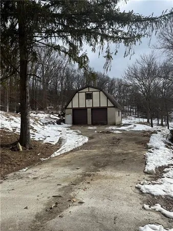 a view of large house with a yard covered in snow