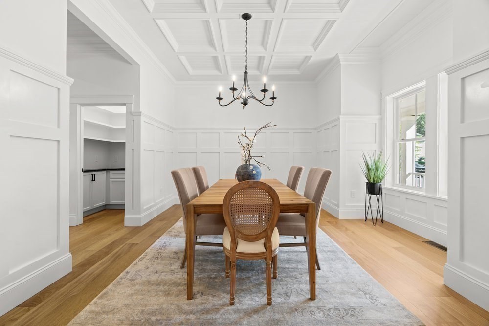 22 Tyler Road Lexington, MA 02420 - Photo 12 of 37 a dining room with furniture a chandelier and wooden floor