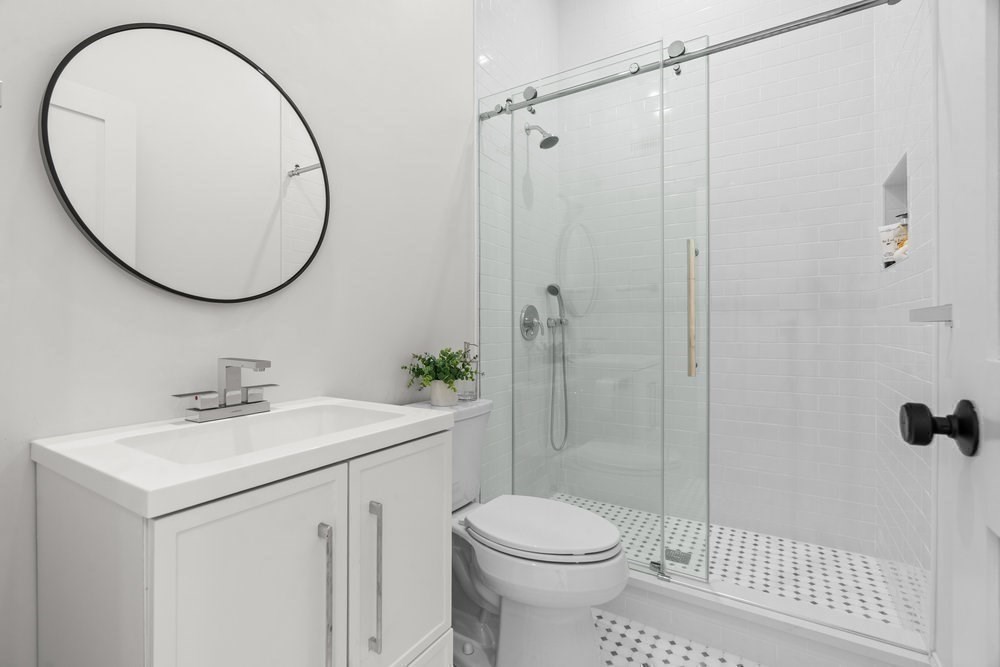 22 Tyler Road Lexington, MA 02420 - Photo 18 of 37 a bathroom with a sink a toilet and a mirror