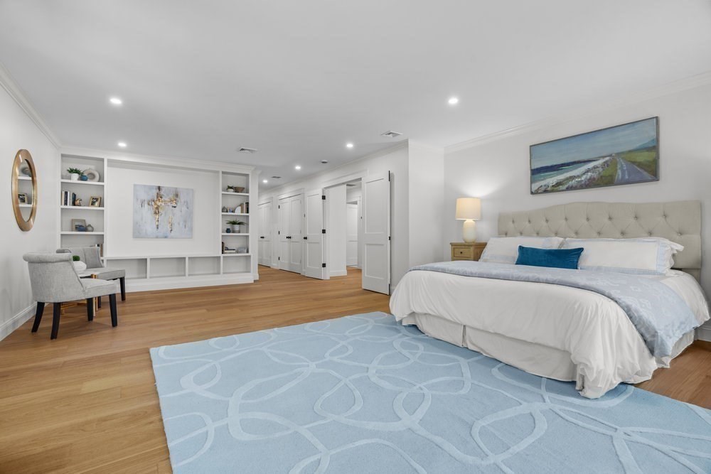 22 Tyler Road Lexington, MA 02420 - Photo 21 of 37 a spacious bedroom with a balcony a bed and a couch