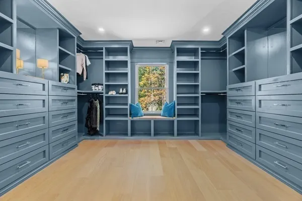 a view of walk in closet with empty racks